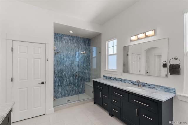 bathroom with a stall shower and vanity