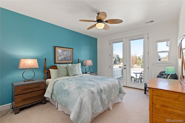 bedroom with access to exterior, french doors, light colored carpet, visible vents, and a ceiling fan