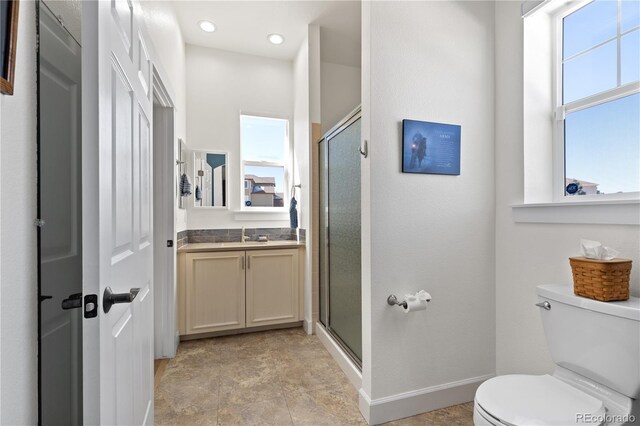 full bath with recessed lighting, toilet, a stall shower, vanity, and baseboards