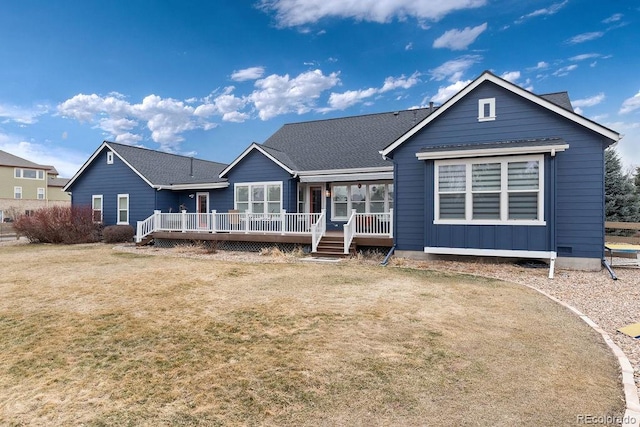 back of property featuring a lawn and a wooden deck