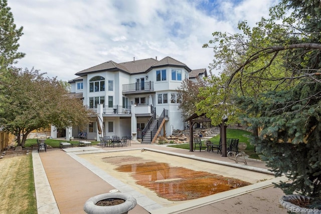 view of property's community with stairs and a patio