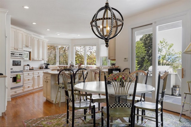 dining space featuring recessed lighting and light wood-style floors