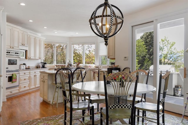 dining area with light wood-style floors and recessed lighting