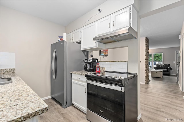 kitchen featuring light wood-type flooring, backsplash, stainless steel appliances, sink, and white cabinetry