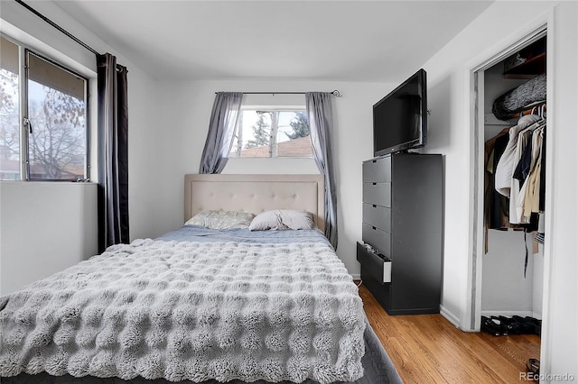 bedroom with wood-type flooring and a closet