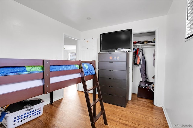 bedroom featuring light hardwood / wood-style flooring and a closet