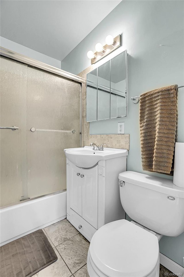 full bathroom featuring vanity, toilet, and bath / shower combo with glass door