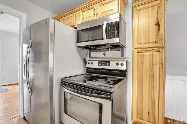 kitchen with light brown cabinets and appliances with stainless steel finishes