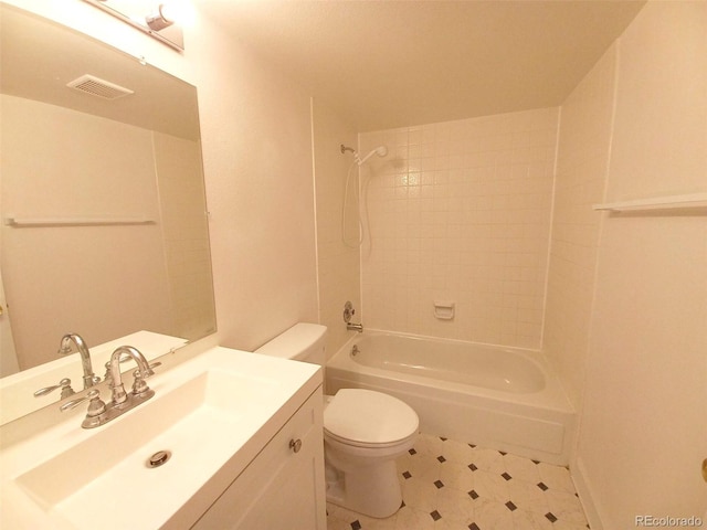 full bathroom with tiled shower / bath, vanity, and toilet