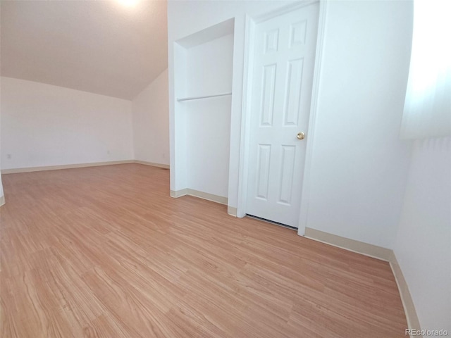 bonus room with lofted ceiling and light hardwood / wood-style floors