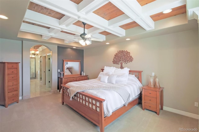 bedroom featuring coffered ceiling, beam ceiling, baseboards, arched walkways, and light colored carpet