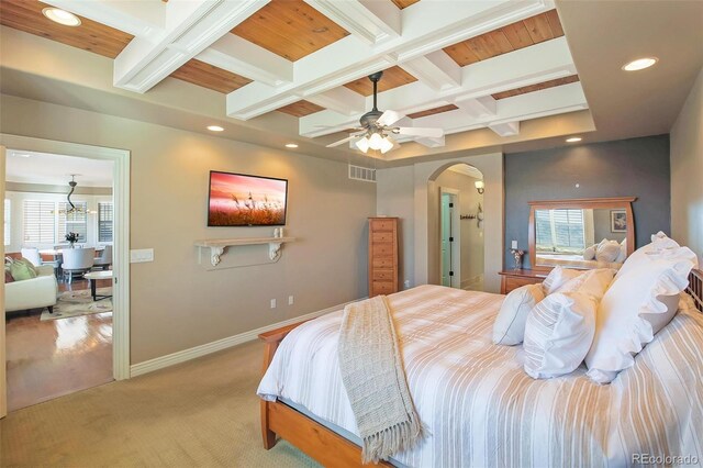 bedroom featuring coffered ceiling, baseboards, arched walkways, beam ceiling, and light colored carpet