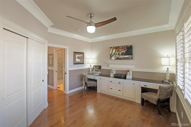 office featuring ceiling fan, light wood-type flooring, crown molding, and baseboards