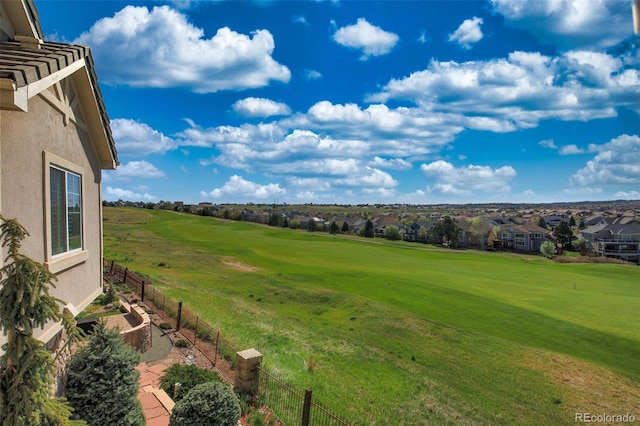 view of yard with view of golf course and a residential view