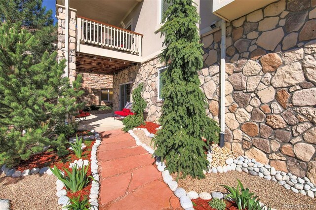 view of yard with a balcony and a patio
