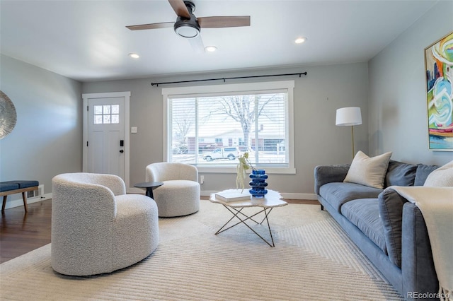 living room with recessed lighting, baseboards, and wood finished floors