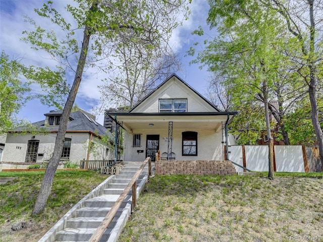 458 S Downing St, Denver, CO 80209 - bungalow-style home with stucco siding, a porch, fence, and stairs