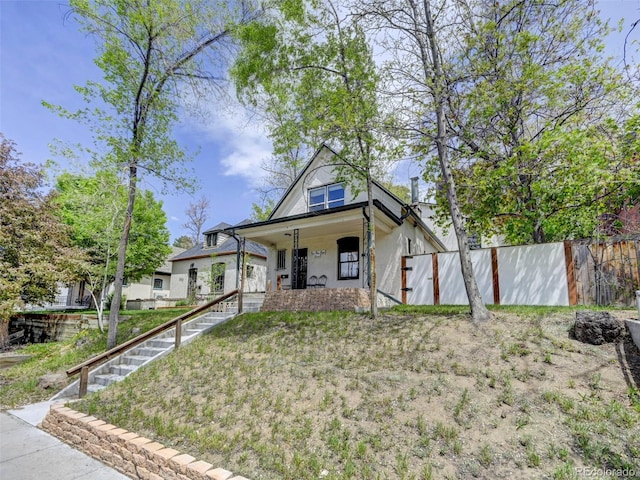 458 S Downing St, Denver, CO 80209 - bungalow-style home featuring covered porch, fence, and stairway