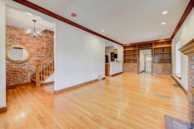 458 S Downing St, Denver, CO 80209 - unfurnished living room featuring brick wall, a chandelier, built in features, wood finished floors, and stairway