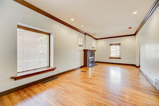 458 S Downing St, Denver, CO 80209 - unfurnished living room with crown molding, light wood-type flooring, baseboards, a fireplace, and recessed lighting
