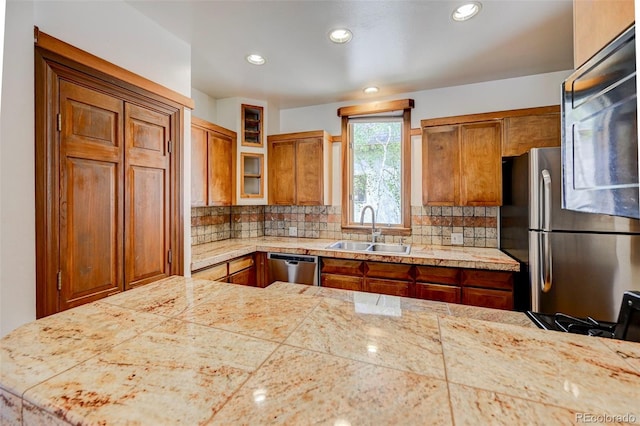 458 S Downing St, Denver, CO 80209 - kitchen featuring a sink, stainless steel appliances, brown cabinets, tile counters, and tasteful backsplash