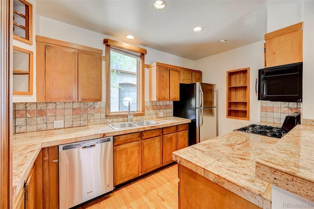 458 S Downing St, Denver, CO 80209 - kitchen featuring black appliances, a sink, glass insert cabinets, brown cabinets, and recessed lighting