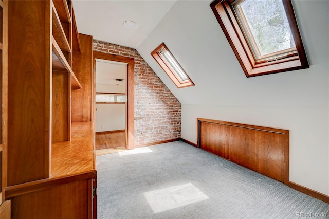 458 S Downing St, Denver, CO 80209 - additional living space featuring brick wall, a skylight, baseboards, carpet, and vaulted ceiling