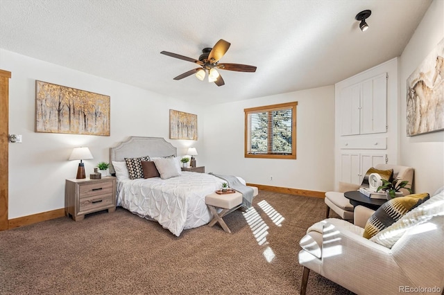 carpeted bedroom with ceiling fan and a textured ceiling