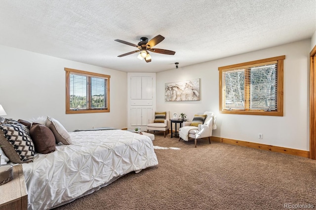 carpeted bedroom with ceiling fan and a textured ceiling