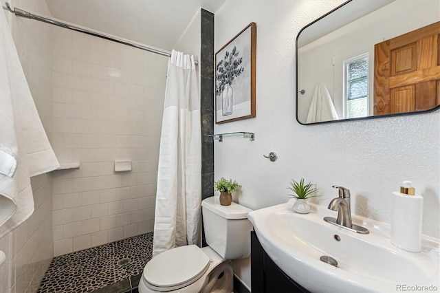 bathroom featuring a shower with curtain, vanity, and toilet