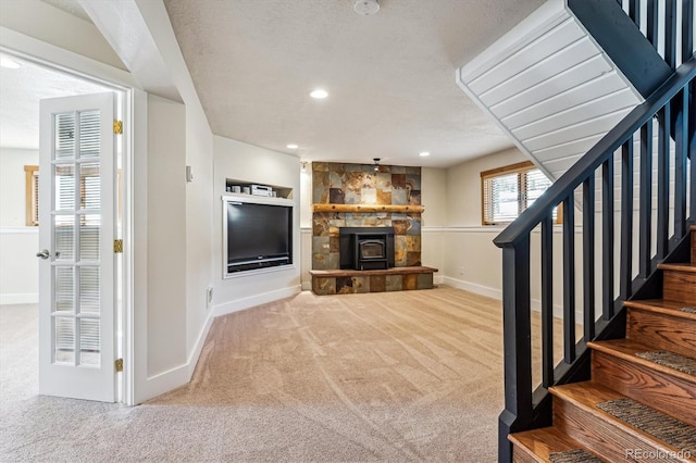 carpeted living room featuring built in shelves and a textured ceiling