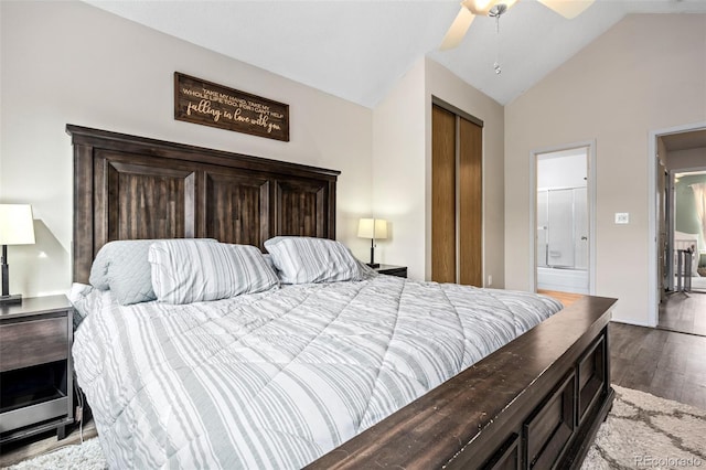 bedroom with a closet, a ceiling fan, connected bathroom, vaulted ceiling, and wood finished floors