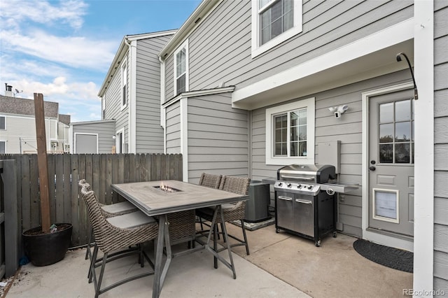 view of patio featuring grilling area, central AC unit, outdoor dining area, and fence