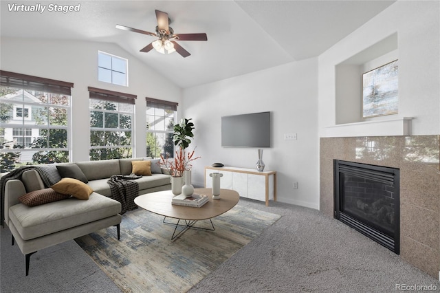 living room with lofted ceiling, carpet, and ceiling fan