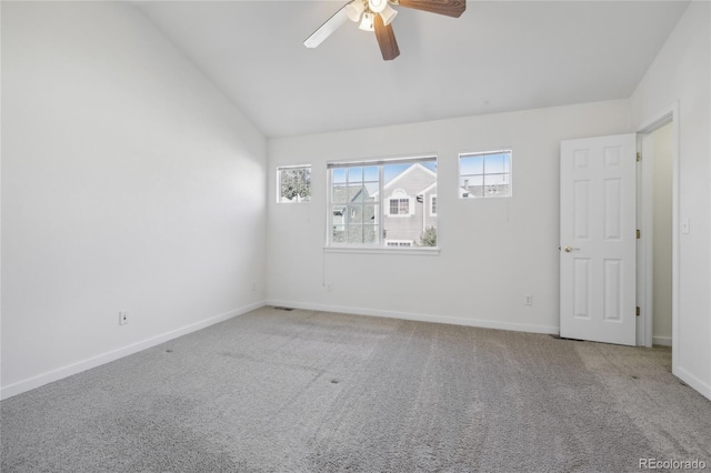 spare room featuring lofted ceiling, carpet flooring, and ceiling fan