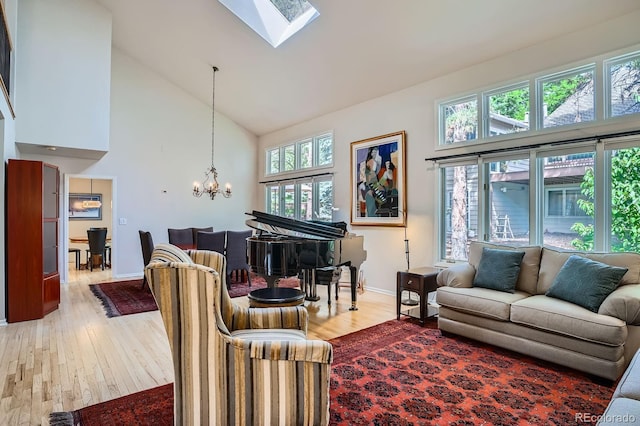 8505 E Temple Dr Unit 473, Denver, CO 80237 - living area featuring high vaulted ceiling, a chandelier, light wood-style floors, and a skylight