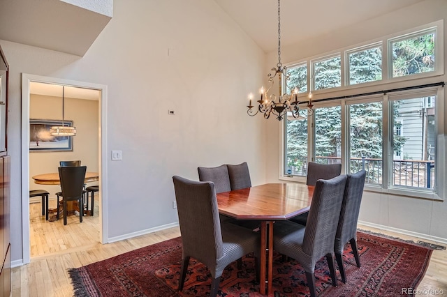 8505 E Temple Dr Unit 473, Denver, CO 80237 - dining room with a chandelier, light wood-type flooring, plenty of natural light, and high vaulted ceiling