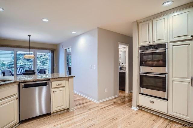 8505 E Temple Dr Unit 473, Denver, CO 80237 - kitchen with stainless steel appliances, light wood-type flooring, recessed lighting, hanging light fixtures, and light stone countertops