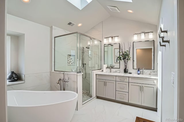 8505 E Temple Dr Unit 473, Denver, CO 80237 - bathroom featuring a marble finish shower, a skylight, double vanity, a freestanding bath, and lofted ceiling