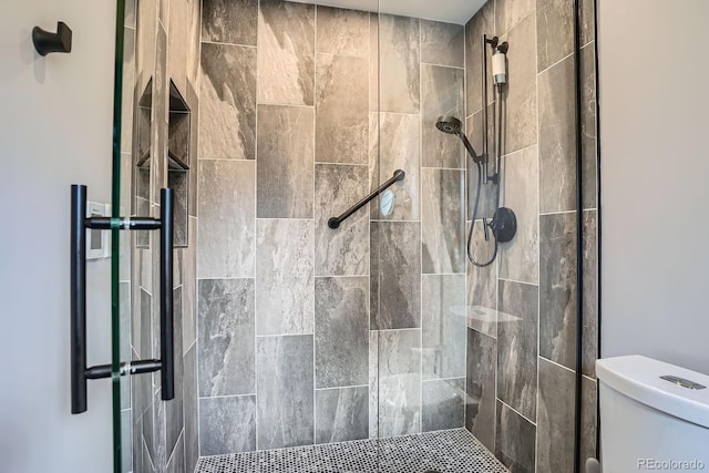 8505 E Temple Dr Unit 473, Denver, CO 80237 - bathroom featuring toilet and a tile shower
