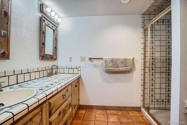 8505 E Temple Dr Unit 473, Denver, CO 80237 - full bathroom with a shower stall, double vanity, a textured ceiling, and a textured wall