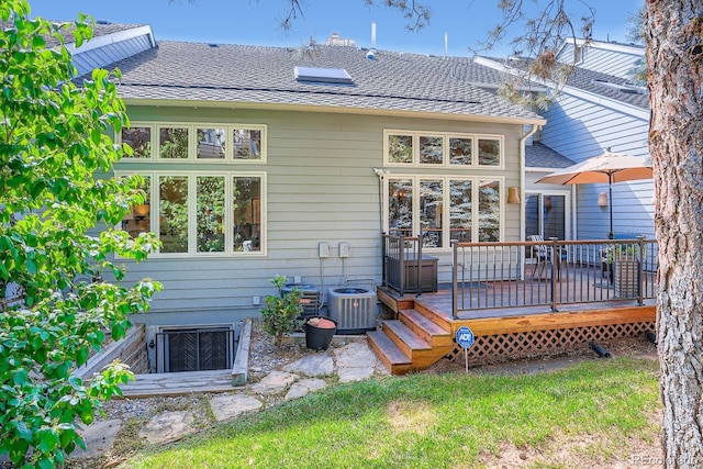 8505 E Temple Dr Unit 473, Denver, CO 80237 - back of house featuring a deck and roof with shingles