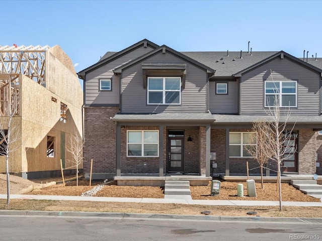 765 N Tibet St, Aurora, CO 80018 - view of front of house with brick siding and roof with shingles