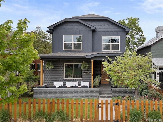 2533 N Emerson St, Denver, CO 80205 - view of front facade with an outdoor living space, board and batten siding, and brick siding