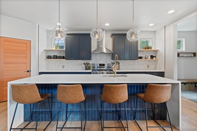 2533 N Emerson St, Denver, CO 80205 - kitchen with open shelves, wall chimney range hood, light wood-type flooring, and light countertops