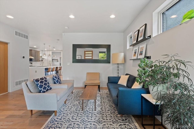 2533 N Emerson St, Denver, CO 80205 - living area featuring wood finished floors, recessed lighting, and baseboards