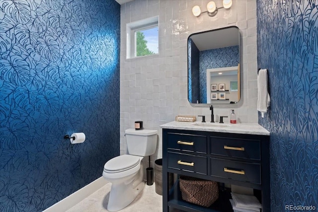 2533 N Emerson St, Denver, CO 80205 - bathroom with toilet, vanity, and tile walls
