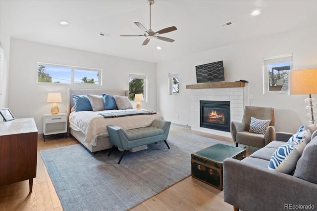 2533 N Emerson St, Denver, CO 80205 - bedroom with a brick fireplace, light wood finished floors, recessed lighting, and a ceiling fan