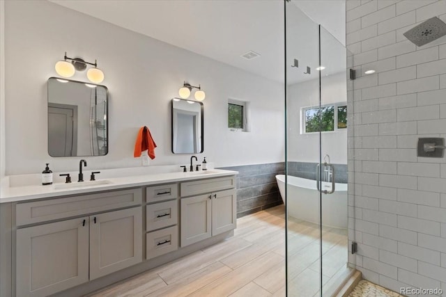 2533 N Emerson St, Denver, CO 80205 - full bath with tiled shower, tile walls, double vanity, and a freestanding bath
