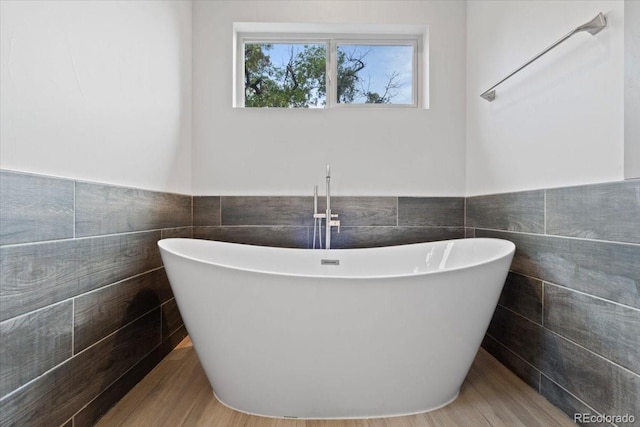2533 N Emerson St, Denver, CO 80205 - full bathroom featuring tile walls, a freestanding bath, and wainscoting